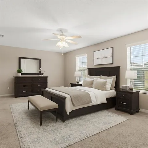 a spacious bedroom with a bed and a dresser