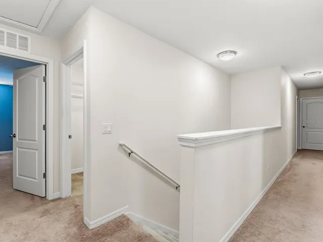 a view of an empty room with windows