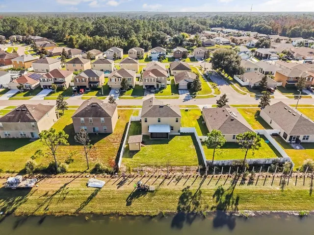 an aerial view of a houses with swimming pool
