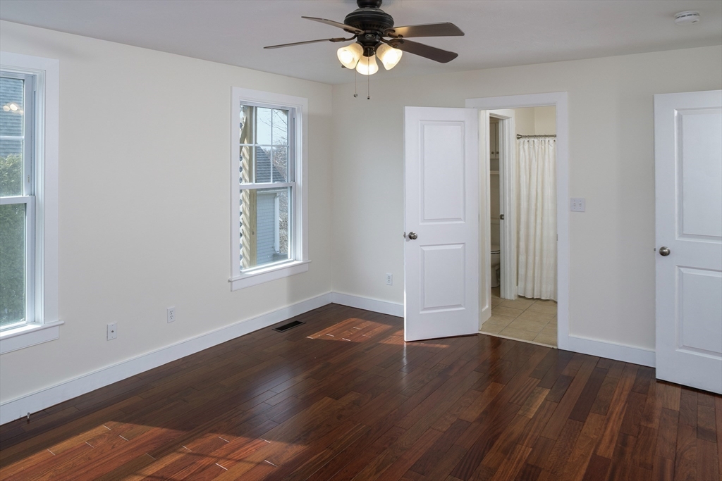 9 Meade Avenue, Unit 1 Hull, MA 02045 - Photo 17 of 34 a view of an empty room with window and wooden floor