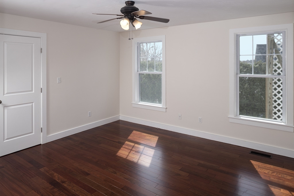 9 Meade Avenue, Unit 1 Hull, MA 02045 - Photo 19 of 34 a view of an empty room with wooden floor and a window
