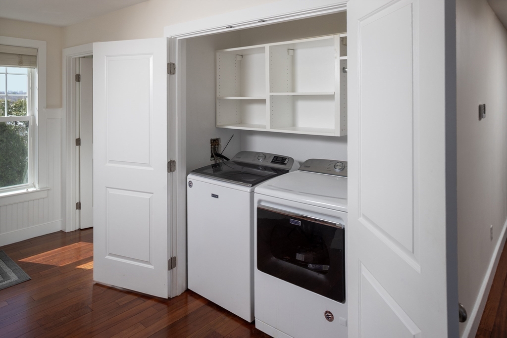 9 Meade Avenue, Unit 1 Hull, MA 02045 - Photo 20 of 34 a utility room with washing machine and wooden floor