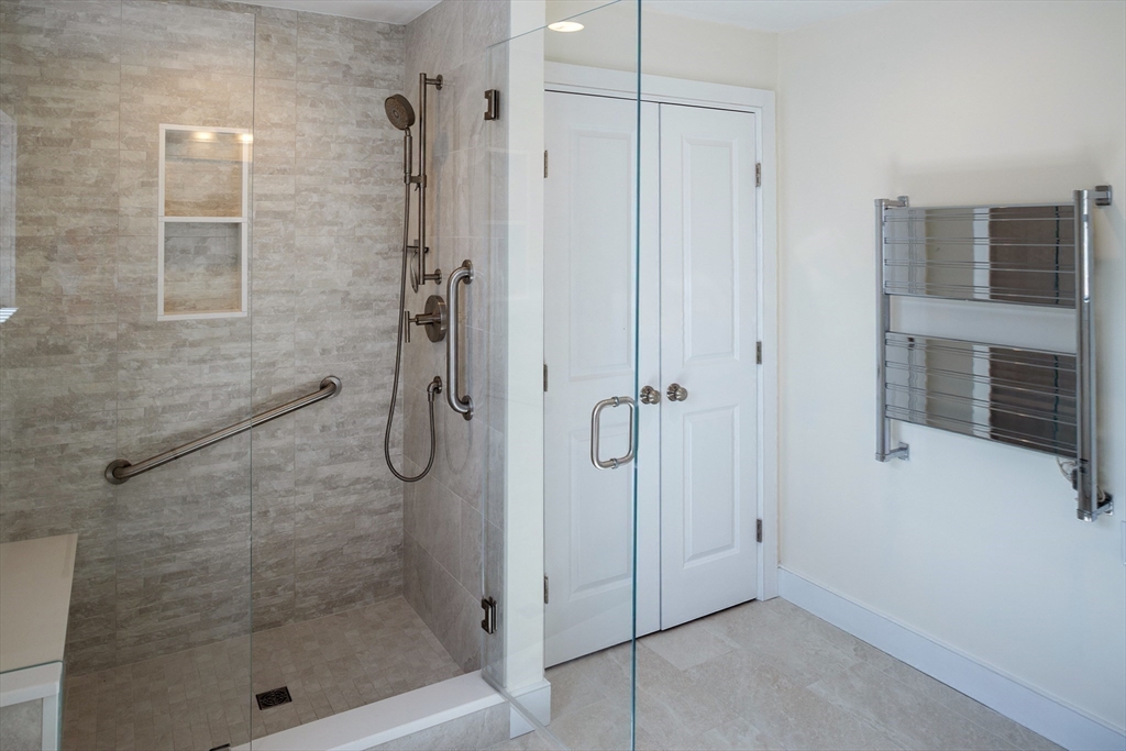 9 Meade Avenue, Unit 1 Hull, MA 02045 - Photo 21 of 34 a bathroom with a glass shower door