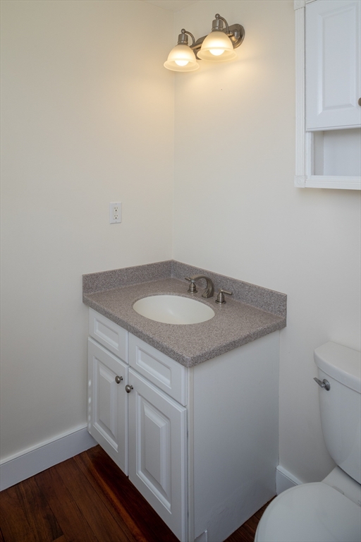 9 Meade Avenue, Unit 1 Hull, MA 02045 - Photo 23 of 34 a bathroom with a granite countertop sink and toilet