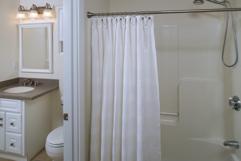 9 Meade Avenue, Unit 1 Hull, MA 02045 - Photo 24 of 34 a bathroom with a granite countertop sink toilet and shower