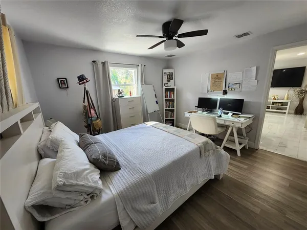 a bedroom with a bed and a view of kitchen
