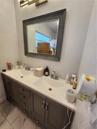 a bathroom with a double vanity sink and a mirror