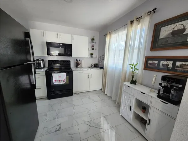 a kitchen with stainless steel appliances a refrigerator sink and stove