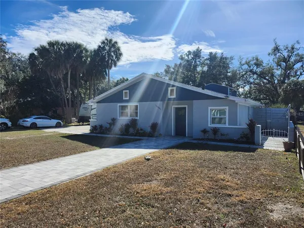 a view of a house with a yard covered in snow