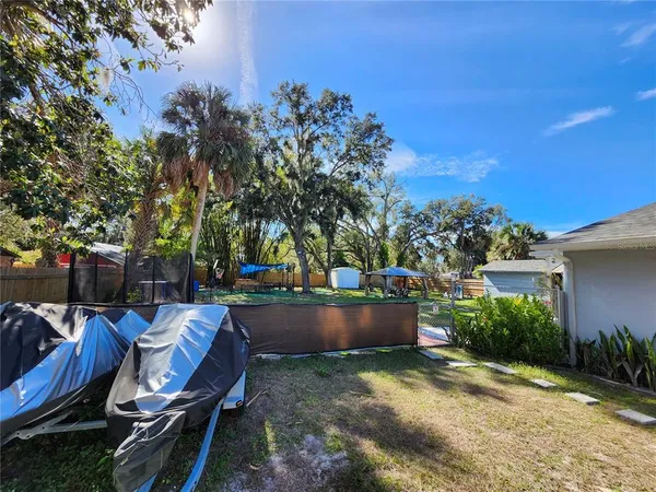 a view of backyard with swimming pool and outdoor seating