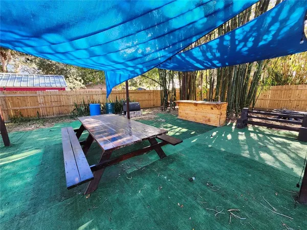 a backyard of a house with a garden and outdoor seating