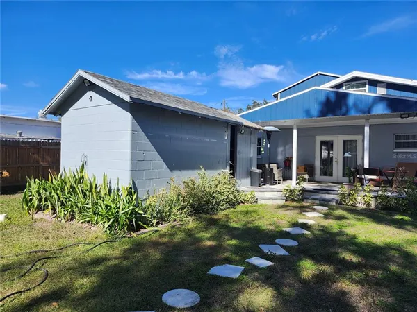 a view of a house with backyard porch and sitting area