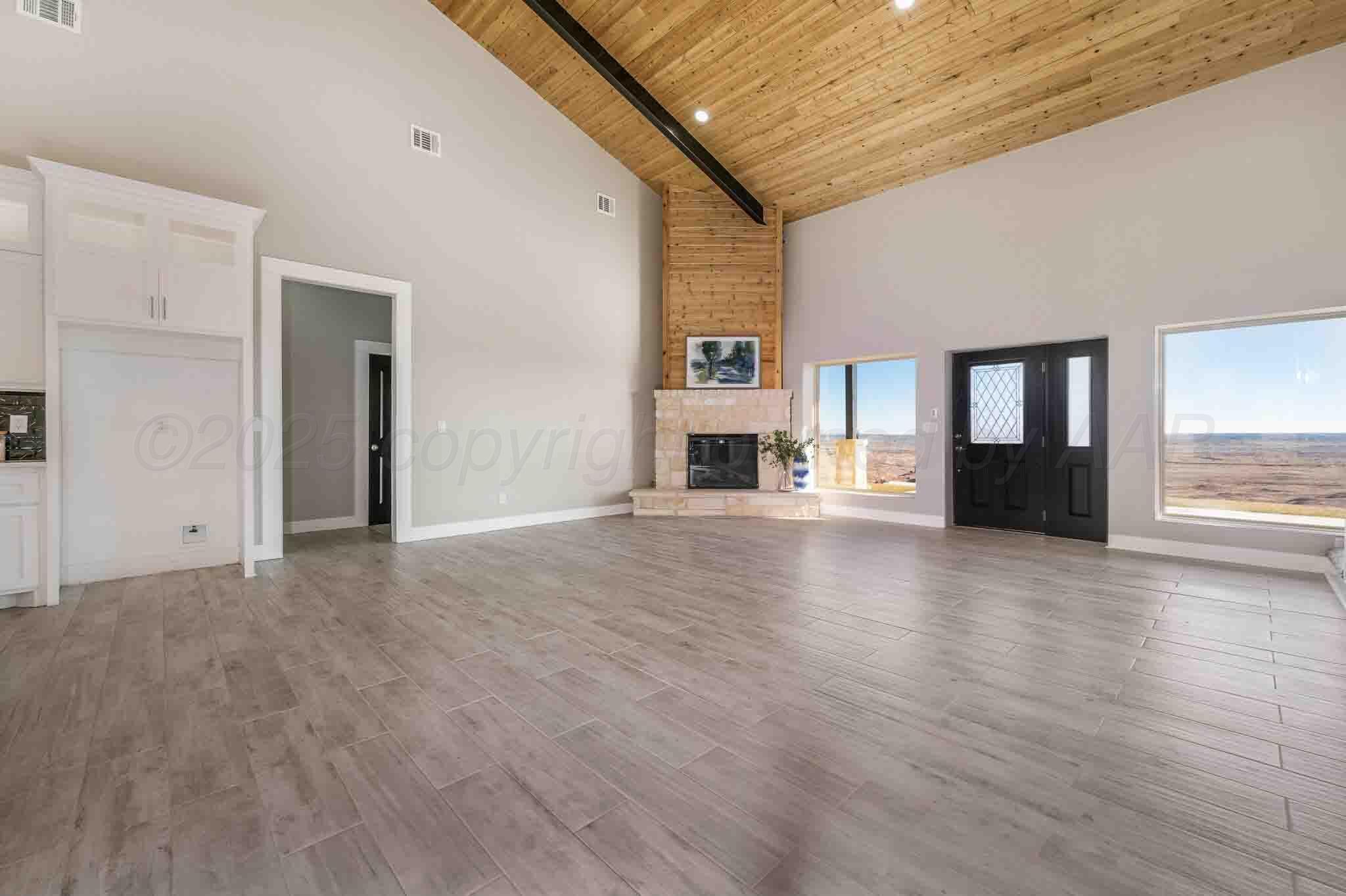 18501 Gold Road Amarillo, TX 79124 - Photo 14 of 48 a view of a livingroom with wooden floor and a fireplace