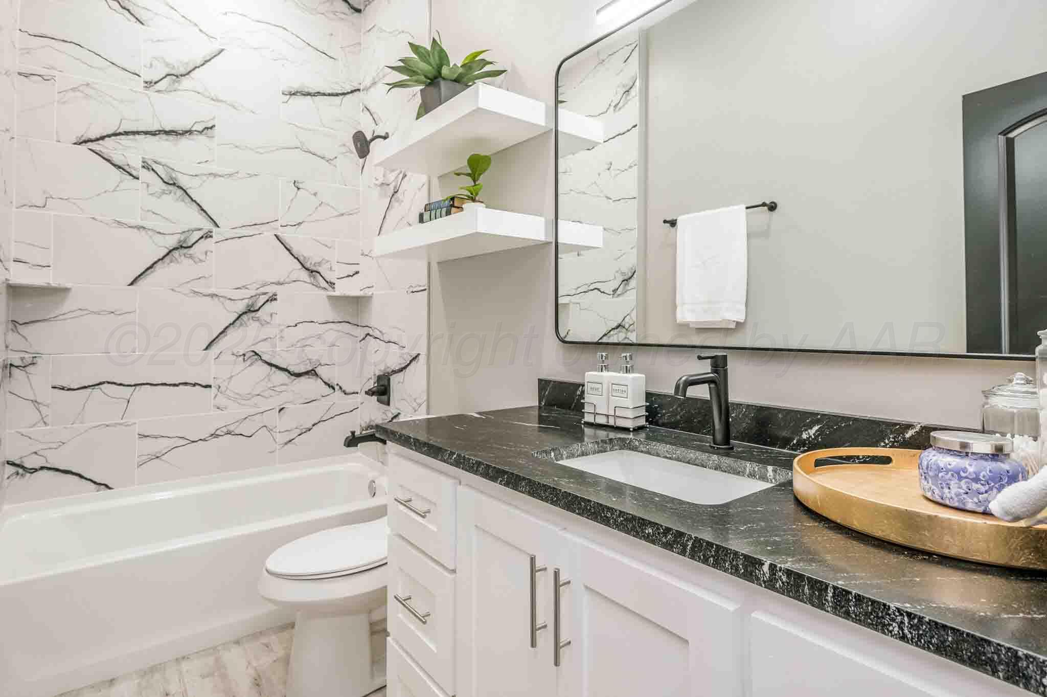 18501 Gold Road Amarillo, TX 79124 - Photo 22 of 48 a bathroom with a granite countertop sink and a mirror