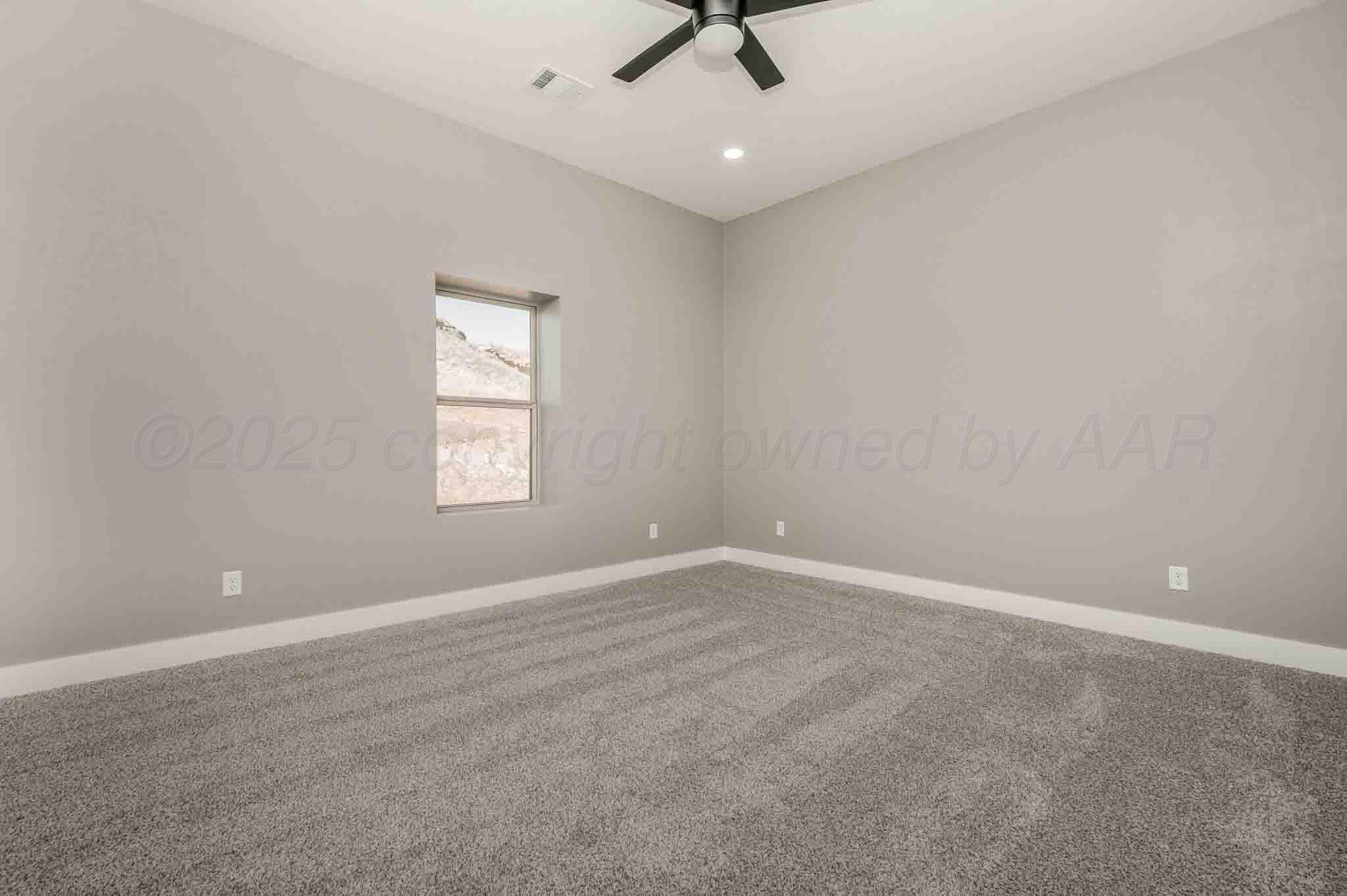 18501 Gold Road Amarillo, TX 79124 - Photo 23 of 48 an empty room with a window and a ceiling fan