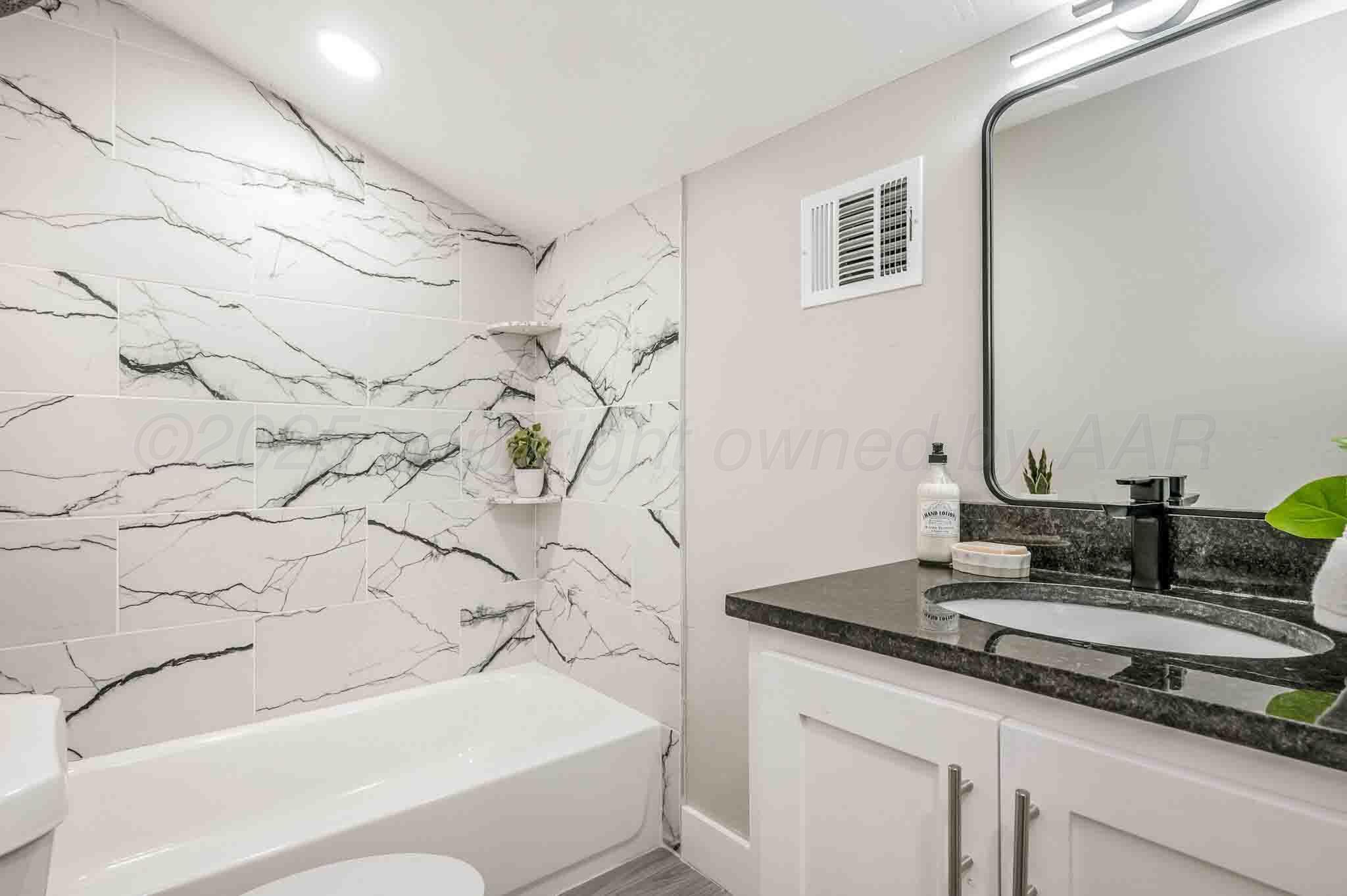 18501 Gold Road Amarillo, TX 79124 - Photo 24 of 48 a bathroom with a granite countertop sink and a mirror