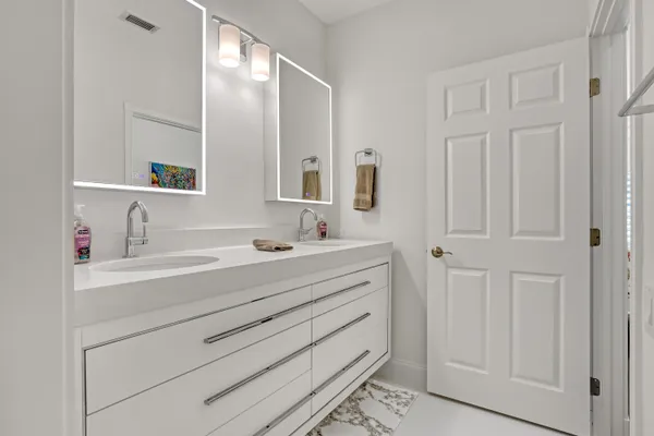 a bathroom with a sink a mirror and shower