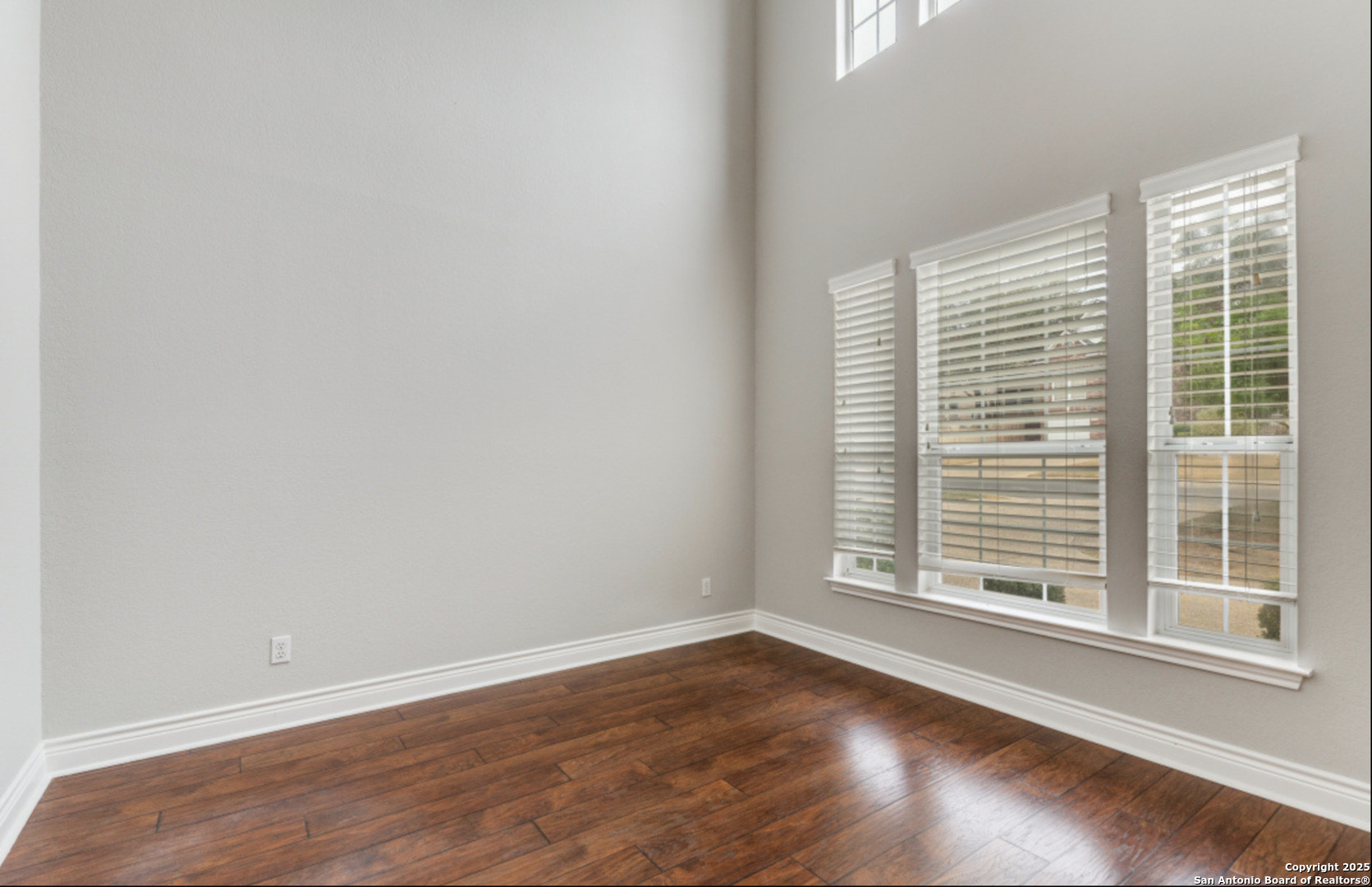 19431 Camino Ridge San Antonio, TX 78258 - Photo 15 of 25 a view of a room with wooden floor and windows