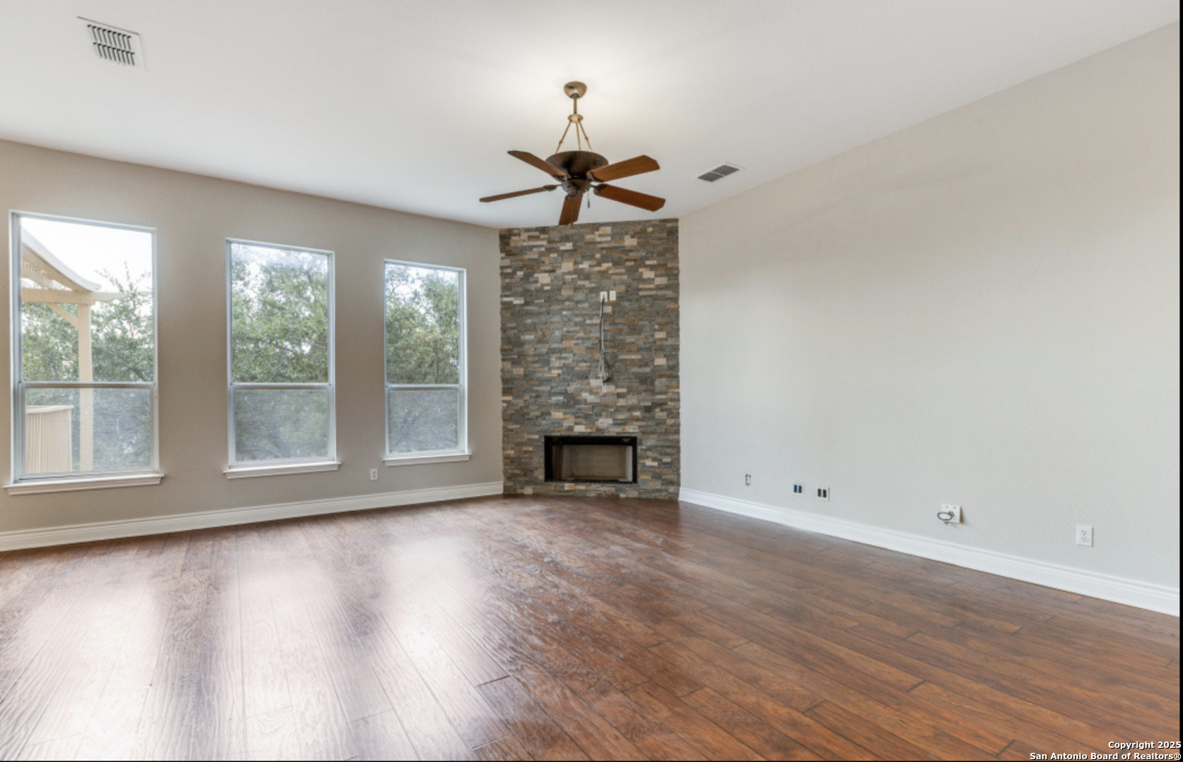 19431 Camino Ridge San Antonio, TX 78258 - Photo 16 of 25 wooden floor in an empty room with a window