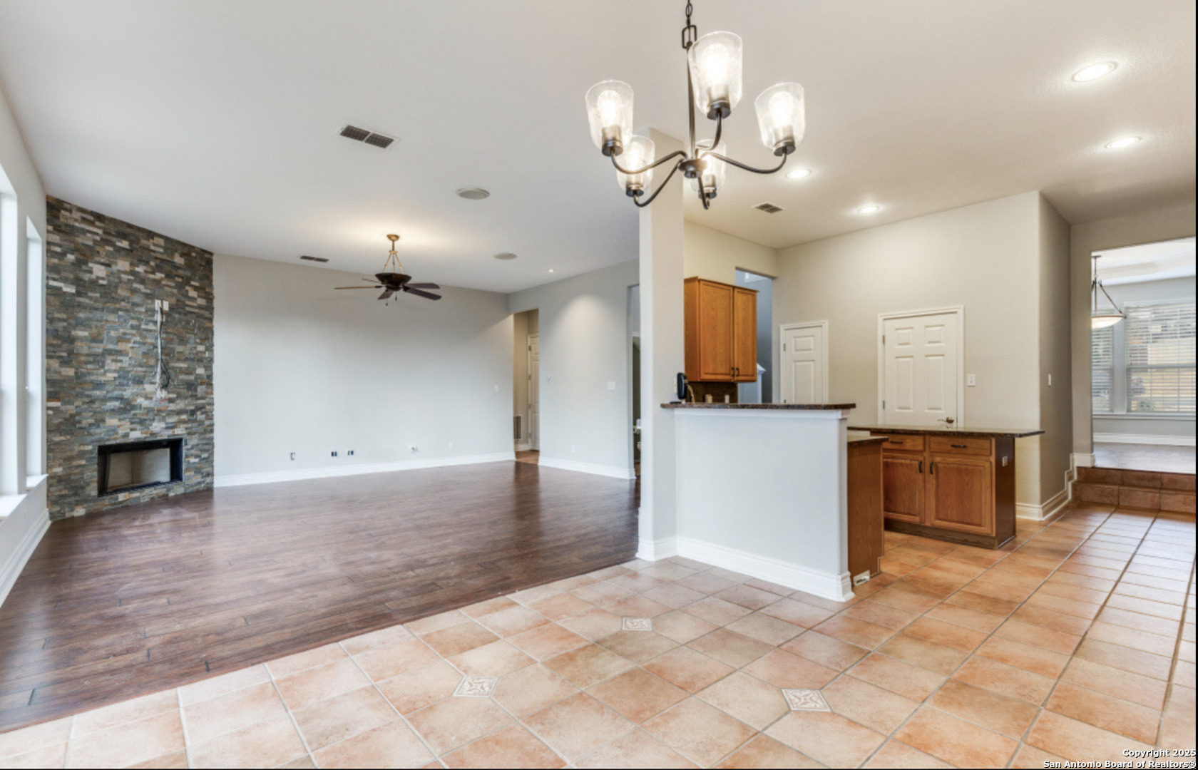 19431 Camino Ridge San Antonio, TX 78258 - Photo 17 of 25 a view of a kitchen with a sink and a fireplace