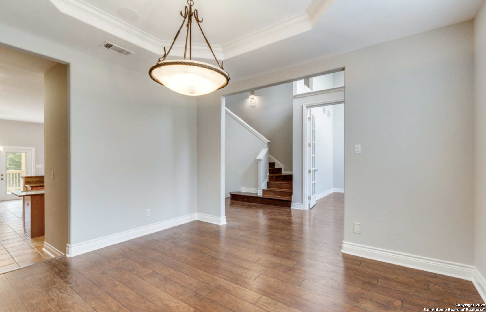 19431 Camino Ridge San Antonio, TX 78258 - Photo 19 of 25 an empty room with wooden floor and windows