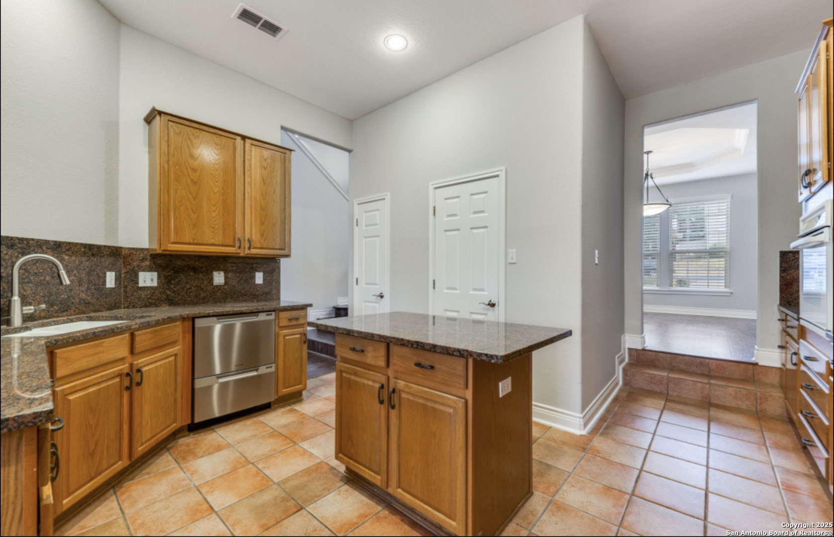 19431 Camino Ridge San Antonio, TX 78258 - Photo 20 of 25 a kitchen with stainless steel appliances granite countertop a sink stove and cabinets