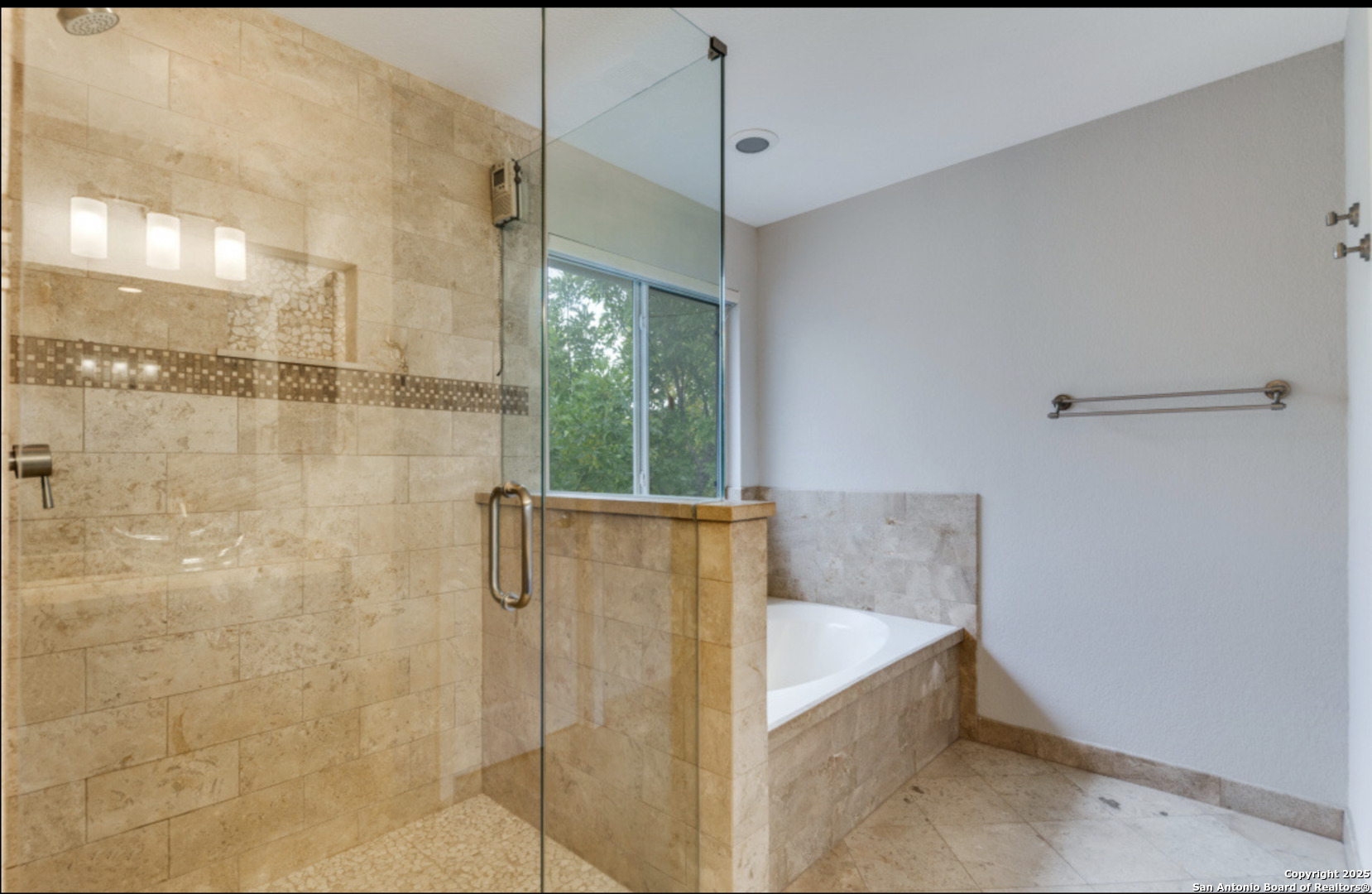 19431 Camino Ridge San Antonio, TX 78258 - Photo 8 of 25 a bathroom with a shower and a bath tub
