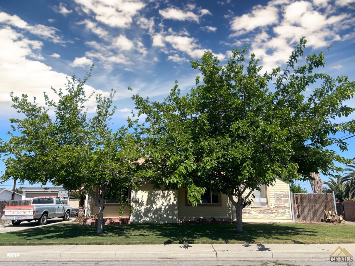 Undisclosed Address Taft, CA 93268 - Photo 2 of 9 a front view of a house with a yard
