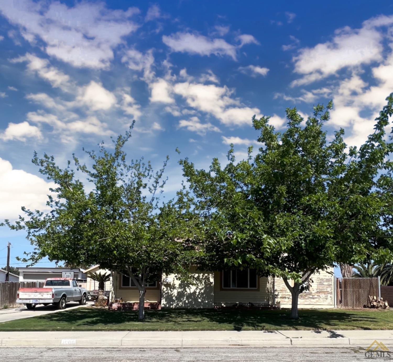 Undisclosed Address Taft, CA 93268 - Photo 4 of 9 a front view of a house with a yard