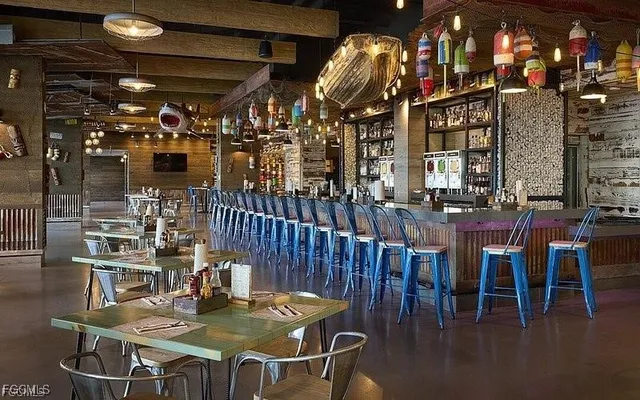 a dining room with furniture and a floor to ceiling window