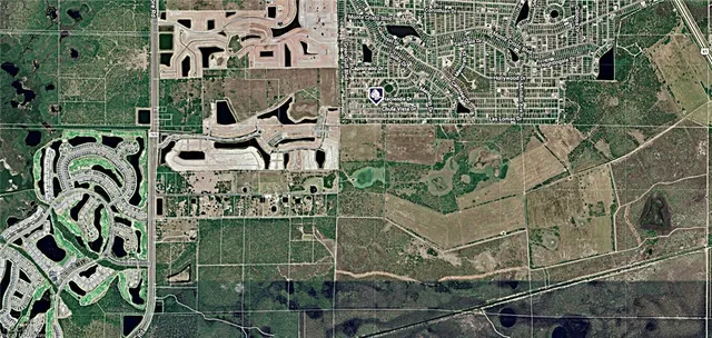 an aerial view of a residential apartment building with a yard