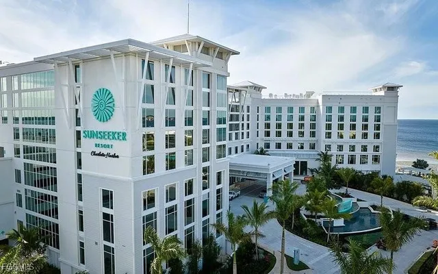 a front view of a building with garden view and plants