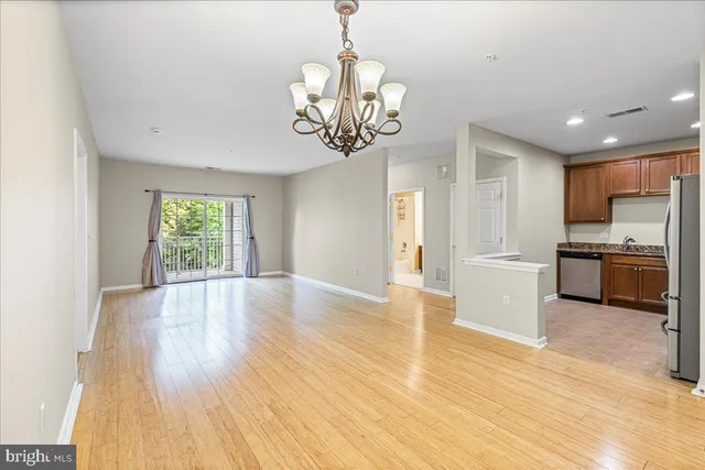 a kitchen with granite countertop stainless steel appliances a refrigerator a stove a microwave and cabinets