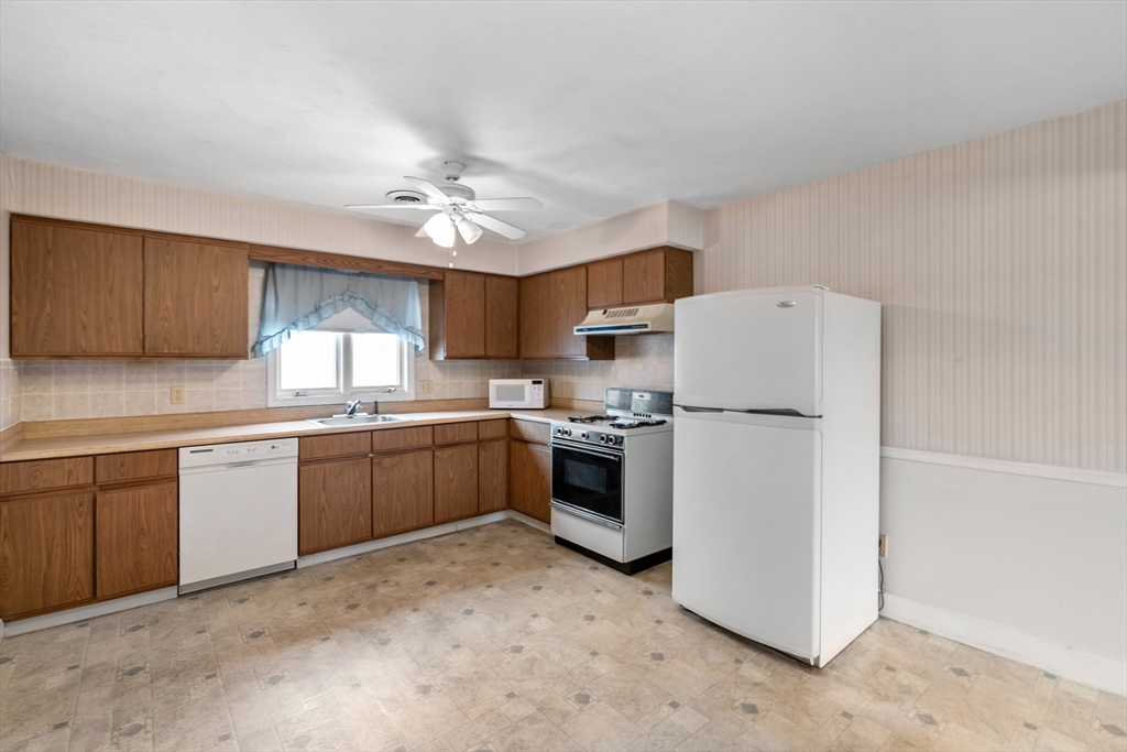 70 North Court Street, Unit F Fall River, MA 02720 - Photo 6 of 20 a kitchen with a refrigerator sink and cabinets
