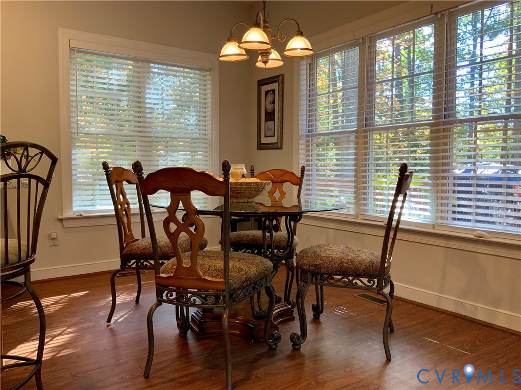 15801 Hampton Summit Lane Chesterfield, VA 23832 - Photo 12 of 42 a view of a dining room with furniture window and wooden floor