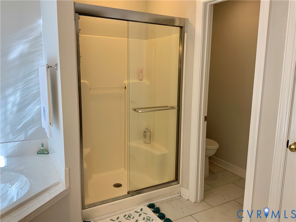 15801 Hampton Summit Lane Chesterfield, VA 23832 - Photo 24 of 42 a bathroom with a glass shower door