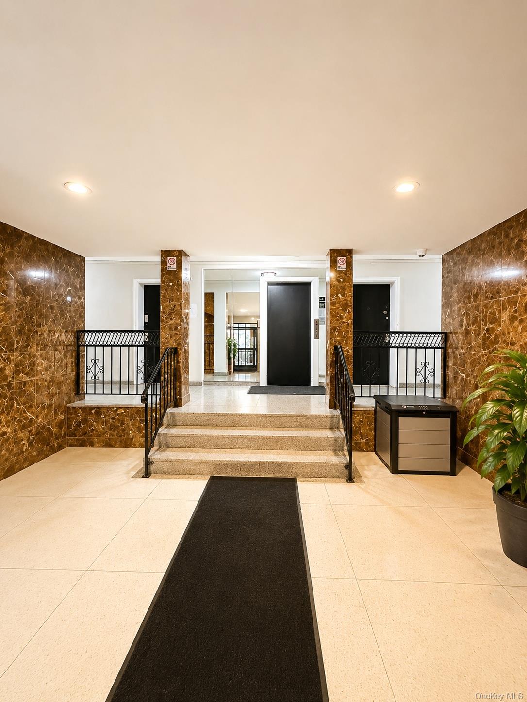 131-11 Kew Gardens Road, Unit 4H Queens, NY 11418 - Photo 2 of 6 lobby entrance with staircase to elevator