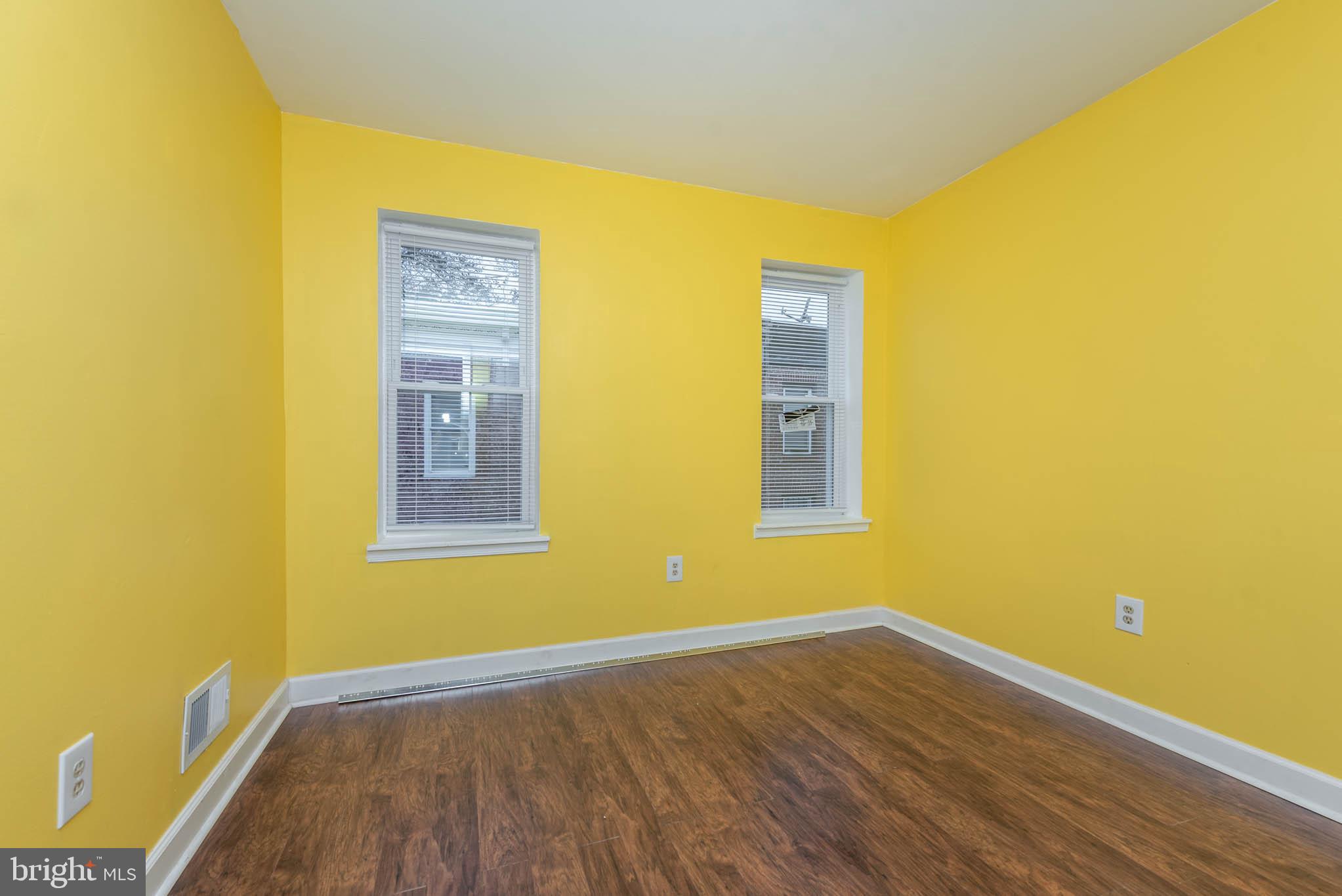 1737 North Dallas Street Baltimore, MD 21213 - Photo 6 of 14 a view of an empty room with wooden floor and a window