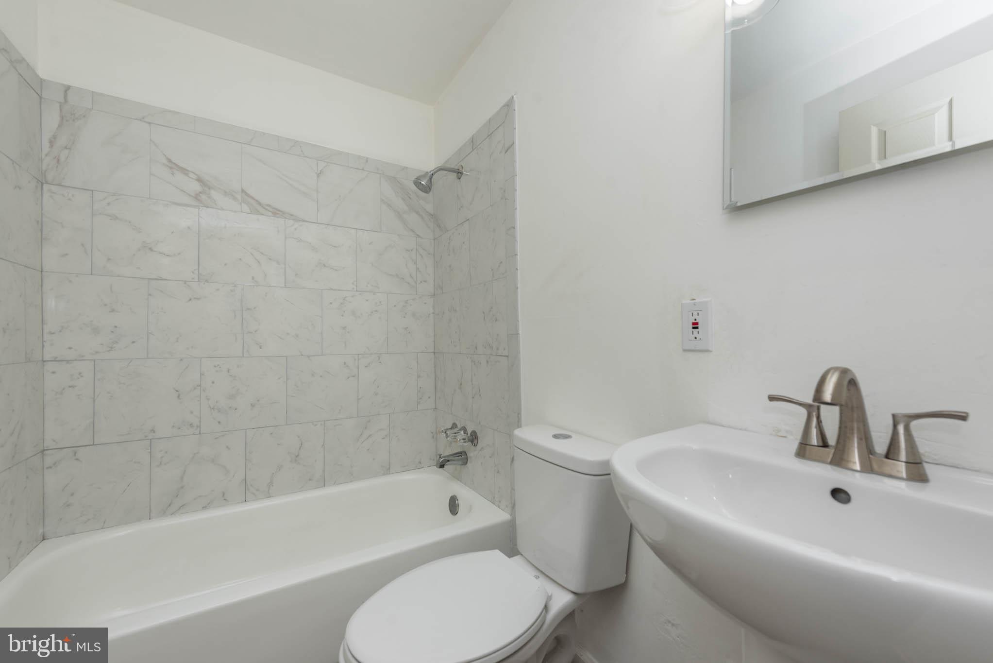 1737 North Dallas Street Baltimore, MD 21213 - Photo 8 of 14 a bathroom with a sink toilet and bathtub