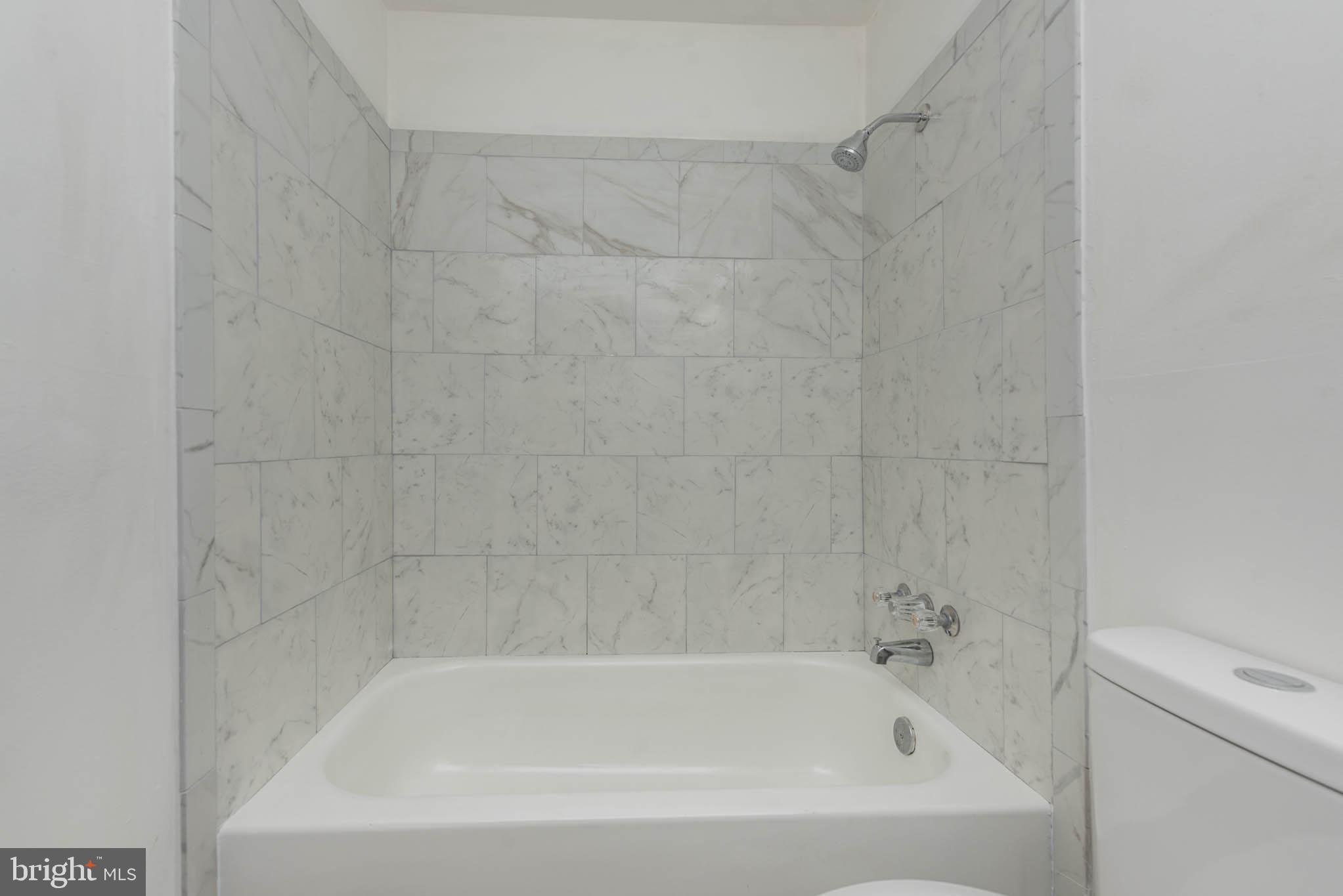 1737 North Dallas Street Baltimore, MD 21213 - Photo 9 of 14 a close up of a bathtub in a bathroom