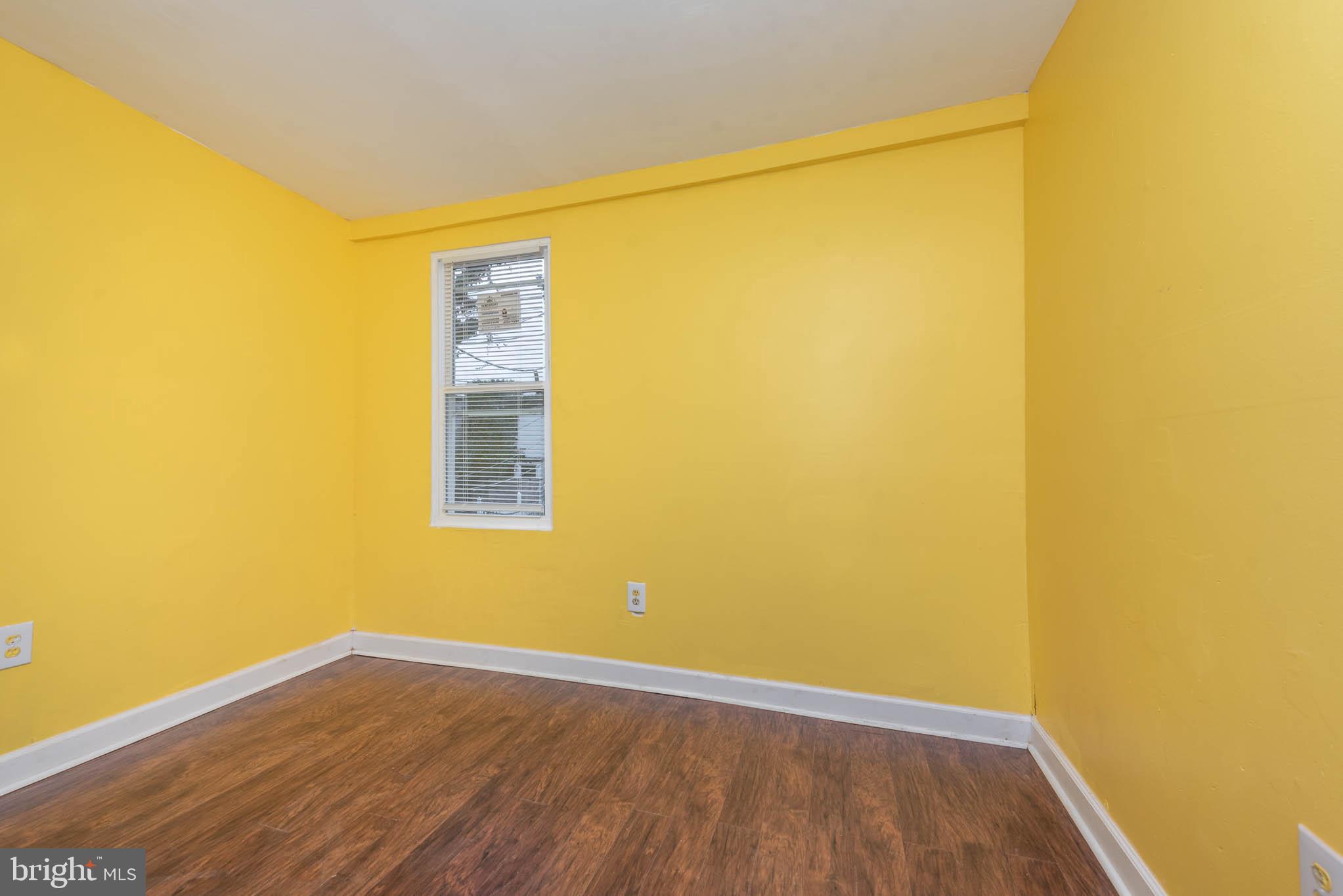 1737 North Dallas Street Baltimore, MD 21213 - Photo 10 of 14 a view of an empty room with wooden floor and a window