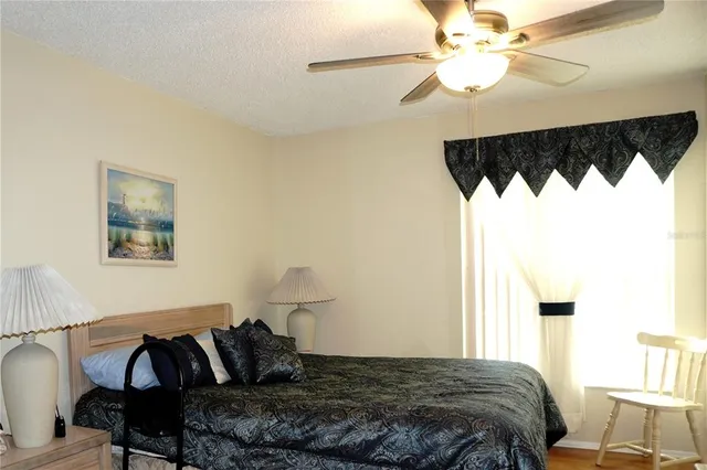 a bedroom with a bed and a painting on the wall