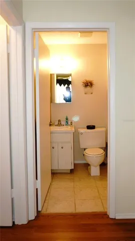 a bathroom with a toilet a sink and a mirror