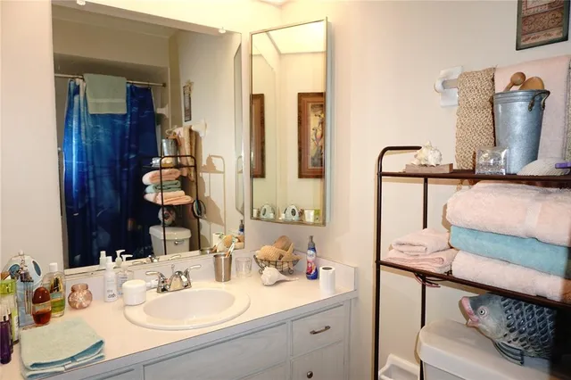 a bathroom with a sink vanity and mirror