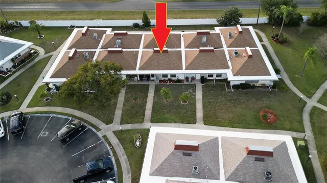 an aerial view of a house with a yard