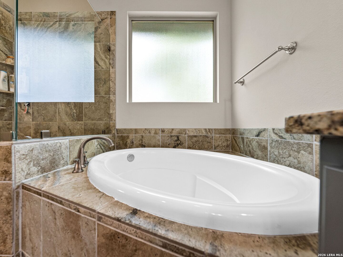 1025 Deep Water Drive Spring Branch, TX 78070 - Photo 19 of 55 a bath tub sitting in a bathroom next to a sink