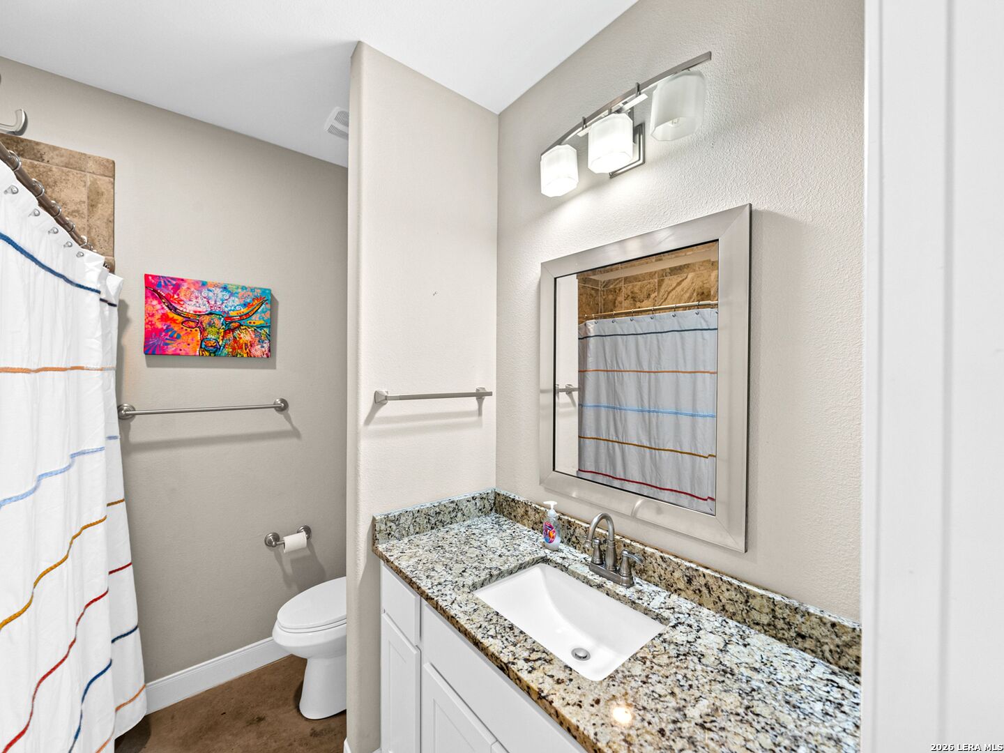 1025 Deep Water Drive Spring Branch, TX 78070 - Photo 33 of 55 a bathroom with a granite countertop sink mirror vanity and toilet