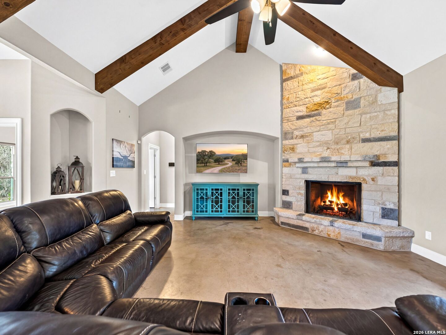 1025 Deep Water Drive Spring Branch, TX 78070 - Photo 7 of 55 a living room with furniture a fireplace and a large window
