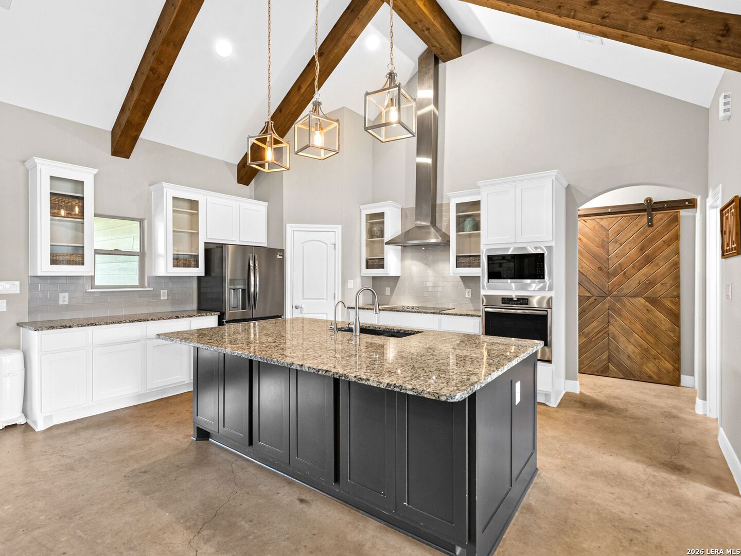 1025 Deep Water Drive Spring Branch, TX 78070 - Photo 10 of 55 a kitchen with stainless steel appliances granite countertop a sink counter space cabinets and a stove