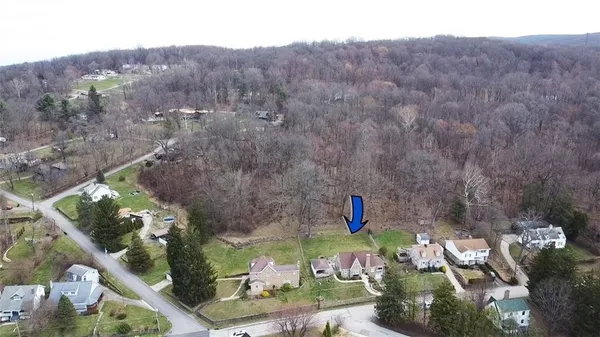 an aerial view of a house with garden space and street view